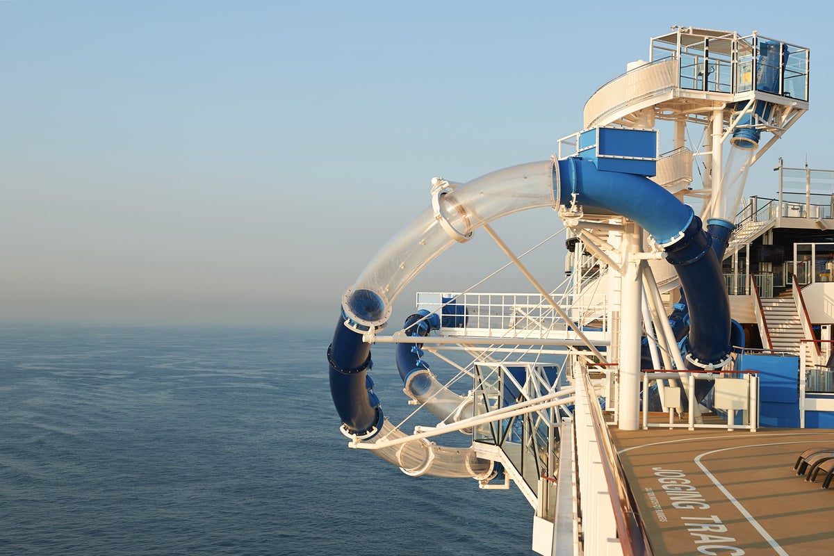Terrifying moment cruise passenger gets stuck dangling in waterslide hanging over the ocean